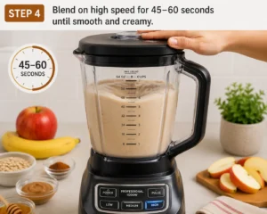 Blending the Apple Cinnamon Smoothie on high speed until smooth and creamy in a blender.
